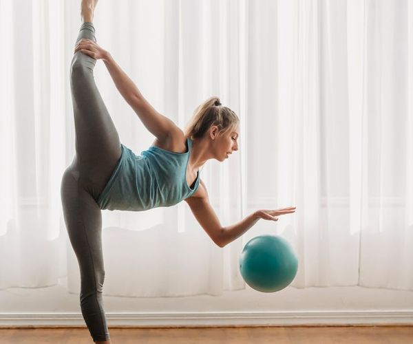Woman performing a yoga pose that demonstrates core strength.